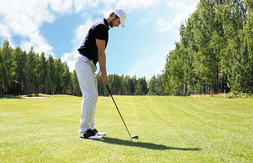 Steps for hitting low golf shots that drive through the wind