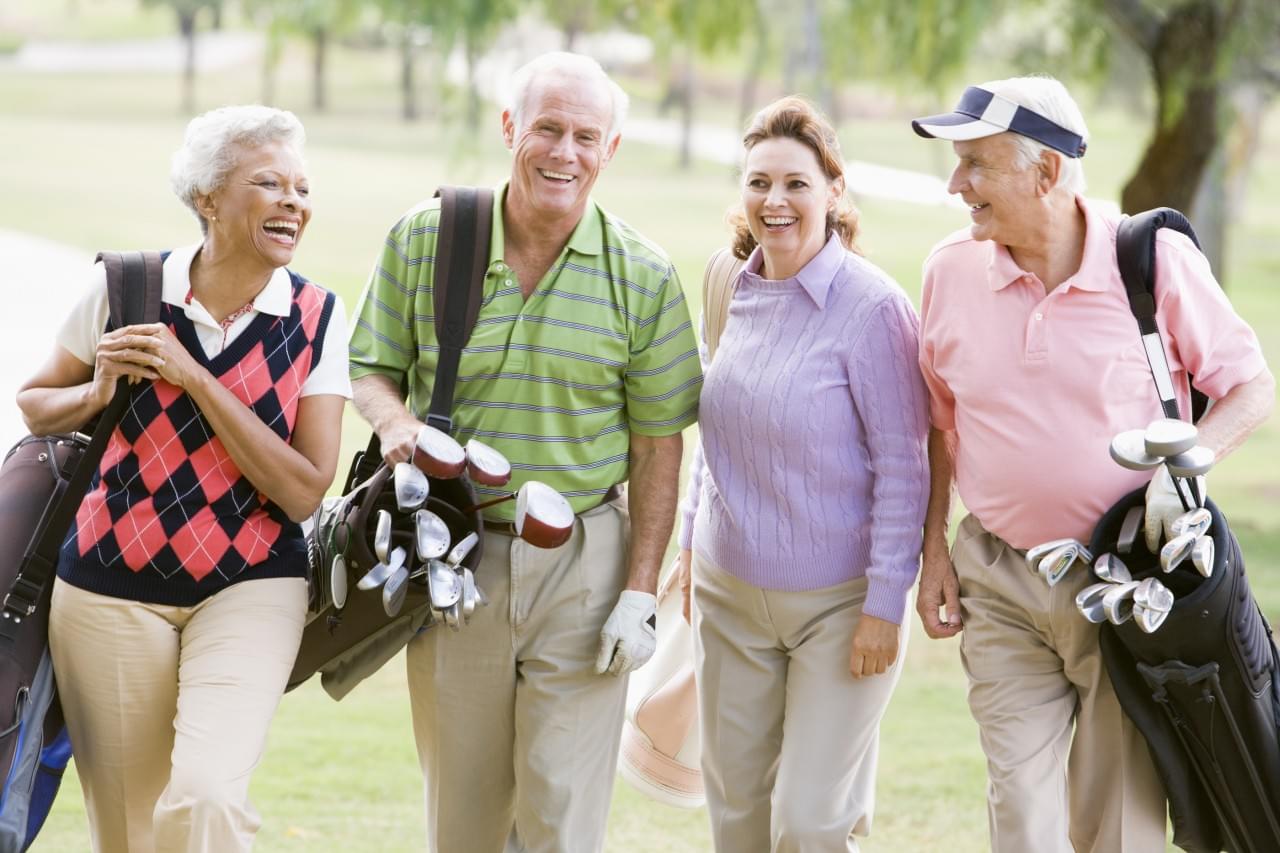 Portrait Of Four Friends Enjoying A Game Golf