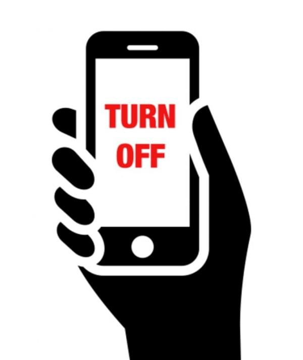 Mobile phone in hand with "turn off" label