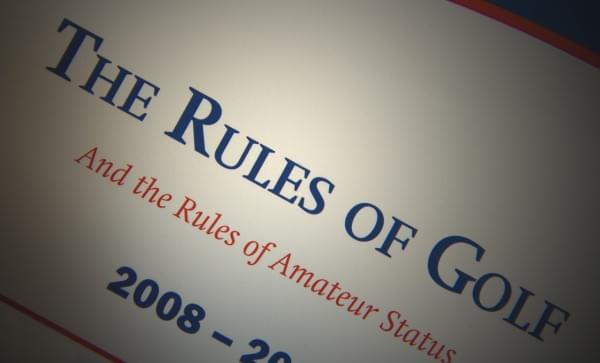 Spotlight on "rules". Closeup of golf manual.
