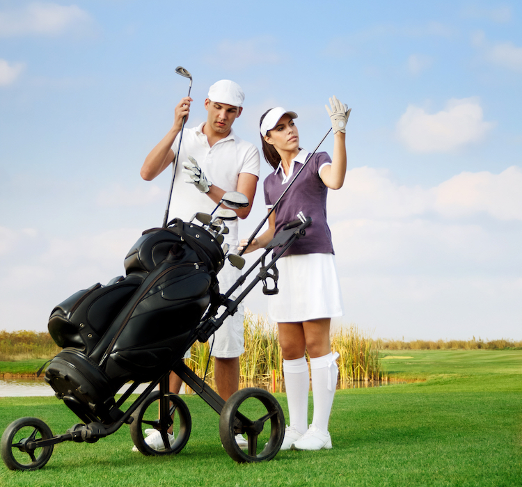 young couple playing golf at the club