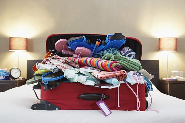 bigstock-Open-suitcase-on-bed-49203935