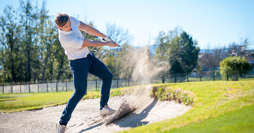 How to swing a golf club out of the bunker